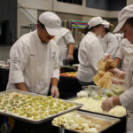 several culinary arts students preparing meals