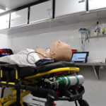 A dummy patient inside of the Medical Simulation Lab trailer